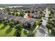 Aerial view of a house with solar panels in a neighborhood, featuring a well-manicured lawn at 16324 Brisk Breeze Aly, Winter Garden, FL 34787