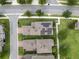 Overhead view of a house with solar panels on the roof, surrounded by trees and green lawns at 16324 Brisk Breeze Aly, Winter Garden, FL 34787