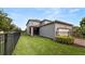 Spacious backyard with a wrought iron fence, lush lawn, and well-maintained landscaping at 16324 Brisk Breeze Aly, Winter Garden, FL 34787