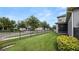 Large backyard featuring green grass, an iron fence, and a screened-in patio at 16324 Brisk Breeze Aly, Winter Garden, FL 34787
