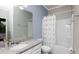The bathroom features granite vanity, white toilet, and a shower with a curtain at 16324 Brisk Breeze Aly, Winter Garden, FL 34787