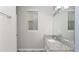 This bathroom has a white vanity, granite counters, and a large mirror at 16324 Brisk Breeze Aly, Winter Garden, FL 34787