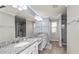 Bright bathroom with dual sinks, granite countertops, and white cabinets at 16324 Brisk Breeze Aly, Winter Garden, FL 34787