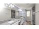 Bathroom with dual sinks, granite countertops, and natural light at 16324 Brisk Breeze Aly, Winter Garden, FL 34787