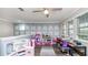 Spacious bonus room featuring custom wall accents, hardwood floors, and plenty of natural light at 16324 Brisk Breeze Aly, Winter Garden, FL 34787
