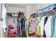 Walk-in closet showing extensive storage with colorful array of clothing at 16324 Brisk Breeze Aly, Winter Garden, FL 34787