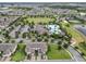 Aerial view featuring a large community pool, clubhouse, and park with lush landscaping and recreational facilities at 16324 Brisk Breeze Aly, Winter Garden, FL 34787