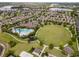 Aerial view of a community pool and recreation area with a large pool, playground, and sports fields at 16324 Brisk Breeze Aly, Winter Garden, FL 34787