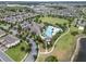 Aerial view featuring a large community pool, clubhouse, and park with lush landscaping and recreational facilities at 16324 Brisk Breeze Aly, Winter Garden, FL 34787