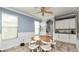Charming dining area with a round wooden table, white chairs, and elegant chandelier at 16324 Brisk Breeze Aly, Winter Garden, FL 34787