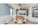 Bright dining area with chandelier, neutral walls, and many windows for natural light at 16324 Brisk Breeze Aly, Winter Garden, FL 34787