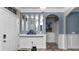 The entryway shows wall paneling, an arched doorway, a tiled floor, and interior doors at 16324 Brisk Breeze Aly, Winter Garden, FL 34787
