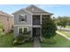 Charming two-story home with a landscaped yard, covered porch, and gray exterior at 16324 Brisk Breeze Aly, Winter Garden, FL 34787