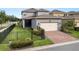 Attractive house featuring brick driveway, fenced yard, and a two-car garage at 16324 Brisk Breeze Aly, Winter Garden, FL 34787