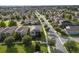 Beautiful community featuring well-maintained homes, lush green lawns, and solar panels, near a serene lake at 16324 Brisk Breeze Aly, Winter Garden, FL 34787