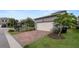 Charming home showcasing brick paver driveway, manicured lawn, and garage at 16324 Brisk Breeze Aly, Winter Garden, FL 34787