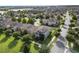 Beautiful community featuring well-maintained homes, lush green lawns, and solar panels, near a serene lake at 16324 Brisk Breeze Aly, Winter Garden, FL 34787