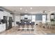 Modern kitchen with stainless steel appliances, granite counters, bar seating, and an adjacent dining area at 16324 Brisk Breeze Aly, Winter Garden, FL 34787