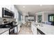 Well-lit kitchen boasts granite counters, stainless steel appliances, and neutral-toned tile flooring at 16324 Brisk Breeze Aly, Winter Garden, FL 34787