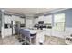 Open kitchen featuring stainless steel appliances, granite countertops, and a kitchen island with bar seating at 16324 Brisk Breeze Aly, Winter Garden, FL 34787