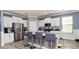 Bright kitchen features stainless steel appliances, white cabinetry, and granite countertops with breakfast bar seating at 16324 Brisk Breeze Aly, Winter Garden, FL 34787