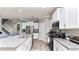 Spacious kitchen with granite countertops, white cabinetry, and stainless steel appliances at 16324 Brisk Breeze Aly, Winter Garden, FL 34787