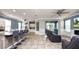 Open living room showing tile floors, ceiling fans, with adjoining kitchen and view to the patio at 16324 Brisk Breeze Aly, Winter Garden, FL 34787