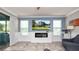 Inviting living room with a modern fireplace, large windows, and sliding glass doors at 16324 Brisk Breeze Aly, Winter Garden, FL 34787