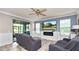 Comfortable living room features sliding glass doors, modern fireplace, and a wall-mounted television at 16324 Brisk Breeze Aly, Winter Garden, FL 34787