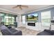 Cozy living room with a modern fireplace, large windows, and stylish decor at 16324 Brisk Breeze Aly, Winter Garden, FL 34787