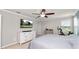 Bright main bedroom with a ceiling fan, natural light, and a television mounted above a modern dresser at 16324 Brisk Breeze Aly, Winter Garden, FL 34787