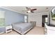 Comfortable main bedroom featuring a ceiling fan, natural light, and a view to the bonus room at 16324 Brisk Breeze Aly, Winter Garden, FL 34787