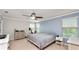 Serene main bedroom with neutral decor, ample natural light, and a ceiling fan for added comfort at 16324 Brisk Breeze Aly, Winter Garden, FL 34787