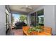 View of this bright, screened patio with brick pavers, seating, and backyard views at 16324 Brisk Breeze Aly, Winter Garden, FL 34787