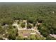 Wide aerial view of a house surrounded by Florida woods, highlighting its private setting and peaceful neighborhood at 21590 Sw 84Th Loop, Dunnellon, FL 34431