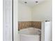 Bathroom featuring a relaxing soaking tub and neutral tile accents at 21590 Sw 84Th Loop, Dunnellon, FL 34431