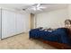 Spacious bedroom featuring white closet doors, ceiling fan, and tile flooring at 21590 Sw 84Th Loop, Dunnellon, FL 34431
