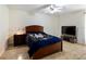 Bedroom featuring a ceiling fan, a full-sized bed, and tile flooring at 21590 Sw 84Th Loop, Dunnellon, FL 34431