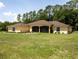 Lovely one story home with a well-maintained lawn, lush greenery, and a screened-in porch at 21590 Sw 84Th Loop, Dunnellon, FL 34431