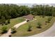 Aerial exterior view of home with lush lawn, mature landscaping, and long driveway at 21590 Sw 84Th Loop, Dunnellon, FL 34431