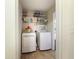 Convenient laundry room with washer, dryer, and storage shelving at 21590 Sw 84Th Loop, Dunnellon, FL 34431