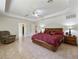 Open main bedroom featuring tiled flooring, tray ceilings, and ample space at 21590 Sw 84Th Loop, Dunnellon, FL 34431