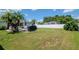 Spacious backyard with lush greenery featuring a covered patio, ideal for outdoor entertaining at 2869 Hickory Ridge Dr, Lakeland, FL 33813