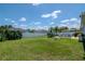 Expansive backyard enclosed with a white fence, complemented by lush green grass and mature trees at 2869 Hickory Ridge Dr, Lakeland, FL 33813