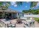 The backyard patio boasts ample seating, a fire pit, and access to the home through sliding glass doors at 2869 Hickory Ridge Dr, Lakeland, FL 33813