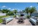 Inviting backyard patio with comfortable seating, a fire pit, and lush tropical landscaping at 2869 Hickory Ridge Dr, Lakeland, FL 33813