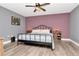 Bedroom features modern ceiling fan, updated floors, and charming wood furnishings at 2869 Hickory Ridge Dr, Lakeland, FL 33813