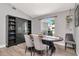 Bright dining room showcasing an oval table, stylish chairs, and dark wood shelving for ample storage at 2869 Hickory Ridge Dr, Lakeland, FL 33813