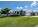 Charming single-story home featuring a lush lawn, mature landscaping, and a classic architectural design at 2869 Hickory Ridge Dr, Lakeland, FL 33813