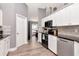 Bright kitchen featuring white cabinets, stainless steel appliances, and wood-look flooring at 2869 Hickory Ridge Dr, Lakeland, FL 33813